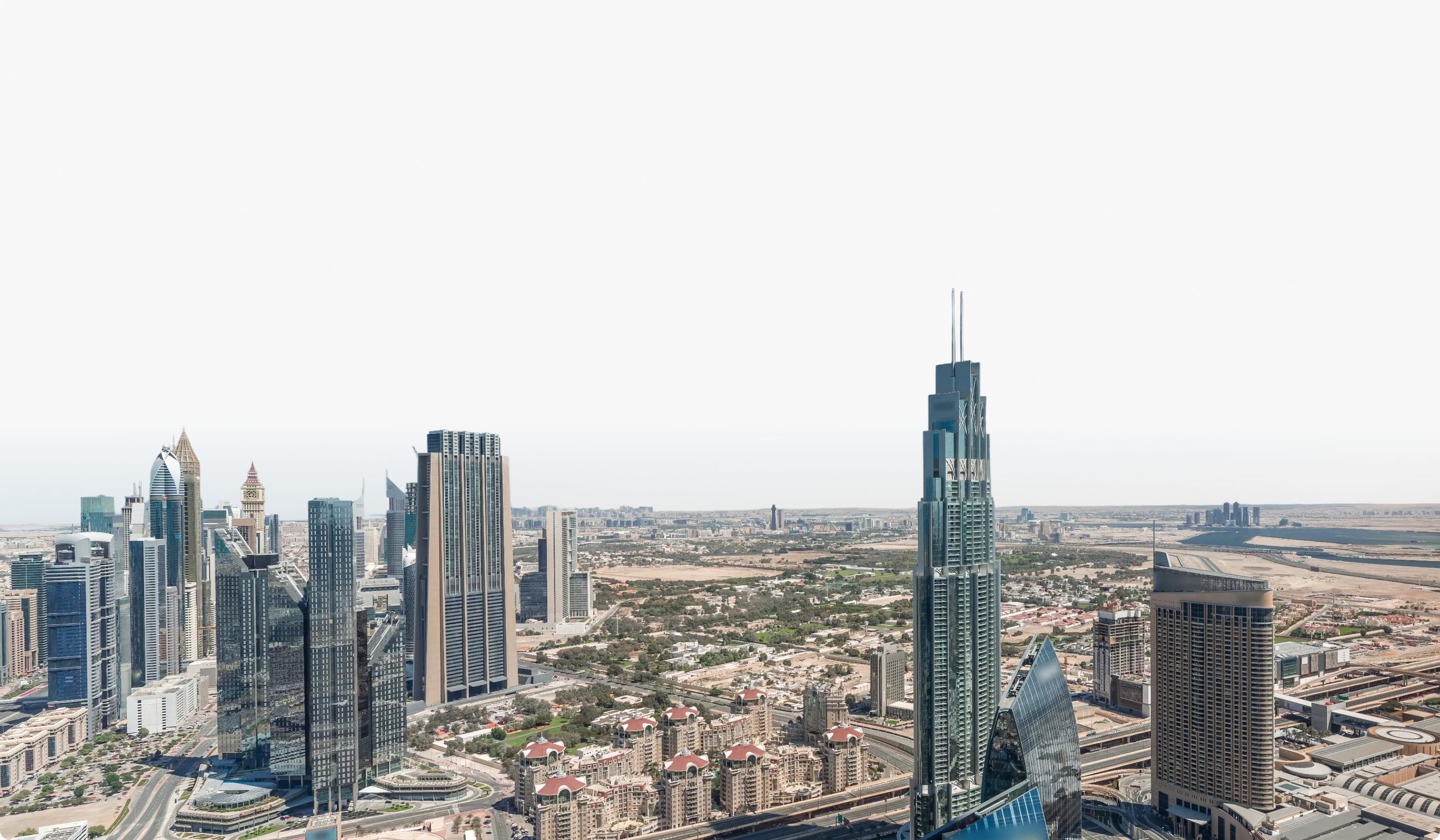 Aerial view of the Dubai skyline with skyscrapers stretching to the desert